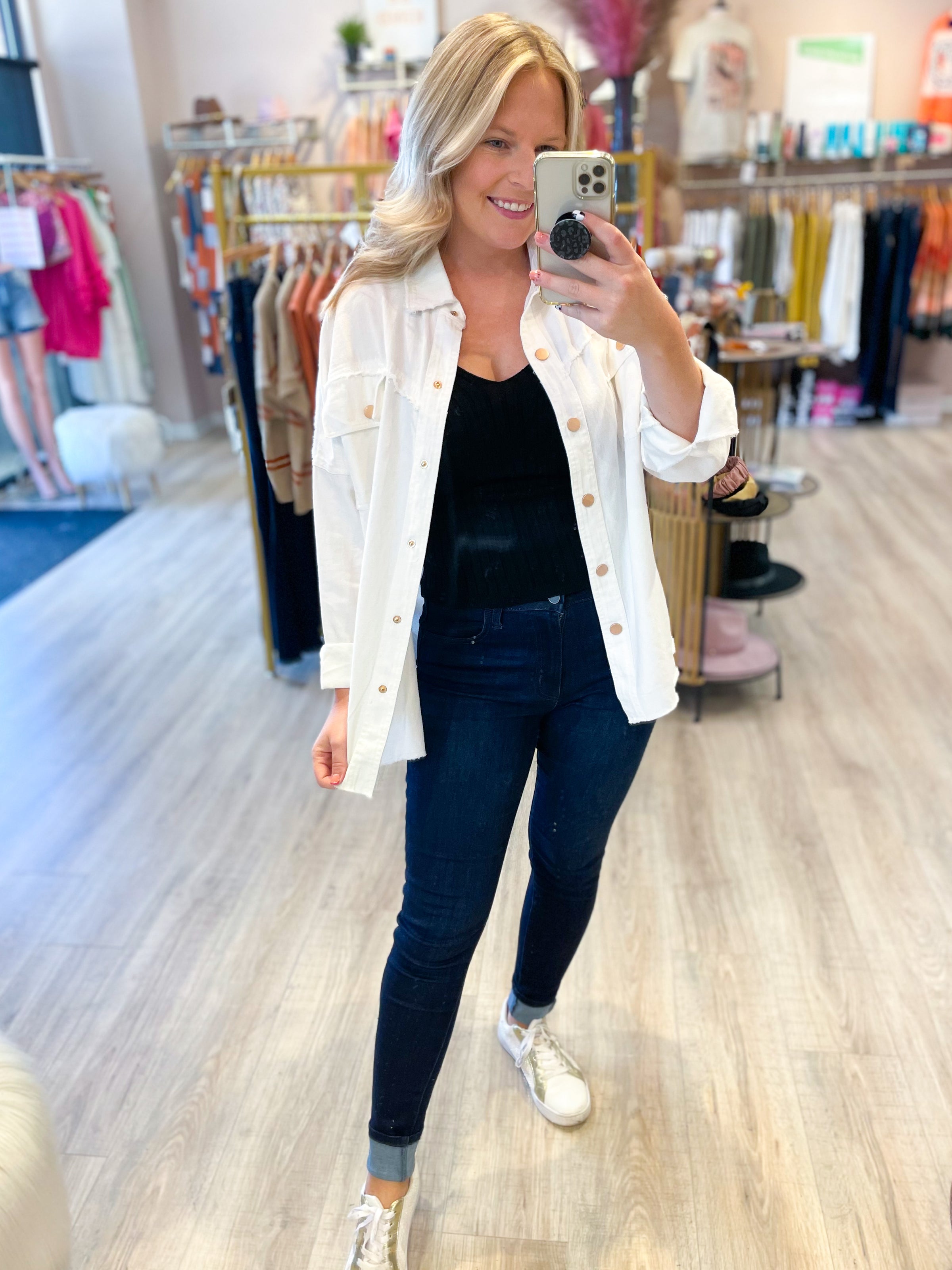 white denim jacket with black peace and peace sign on the back