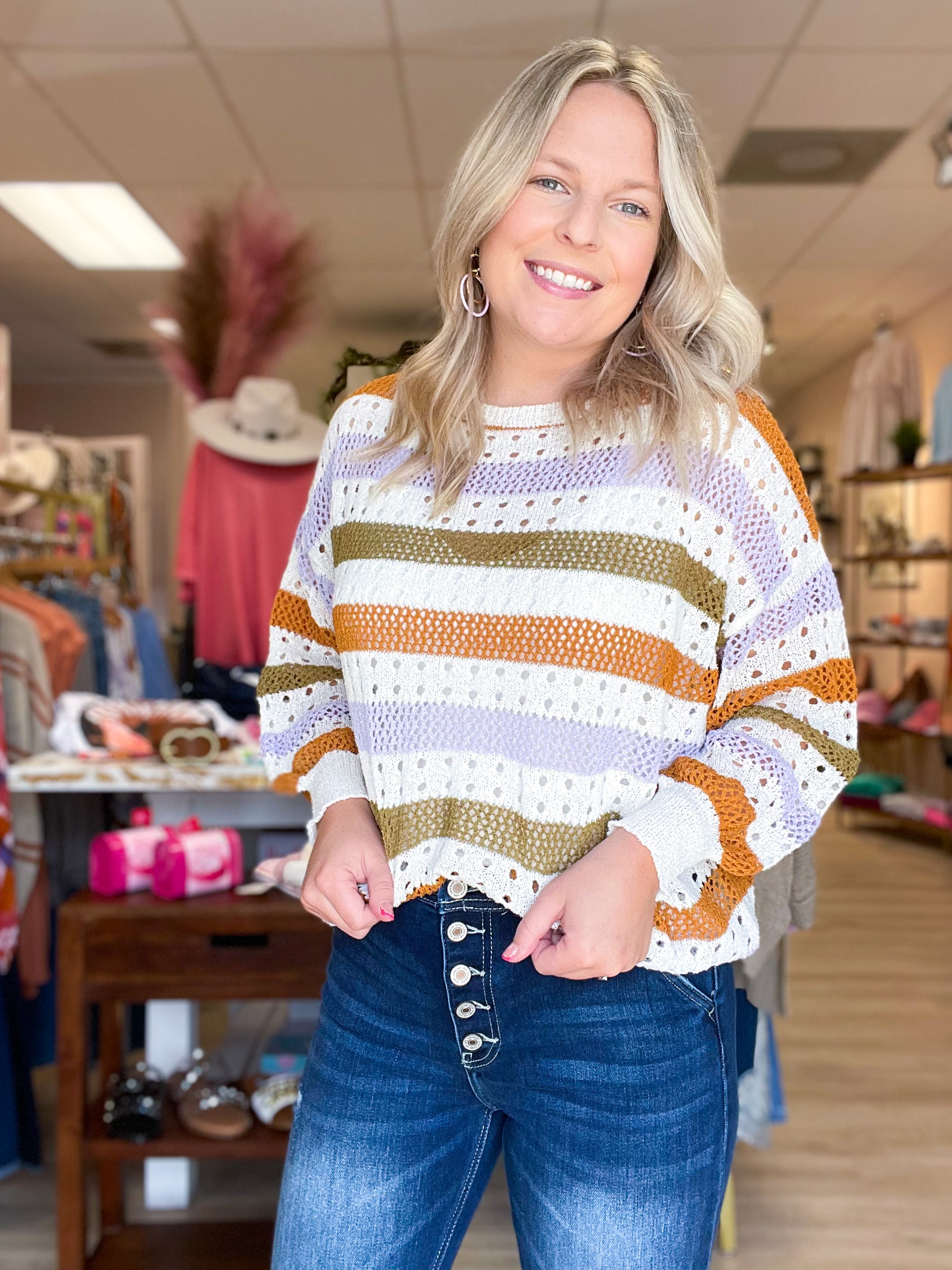 open knit ivory sweater with olive, purple, and rust stripes