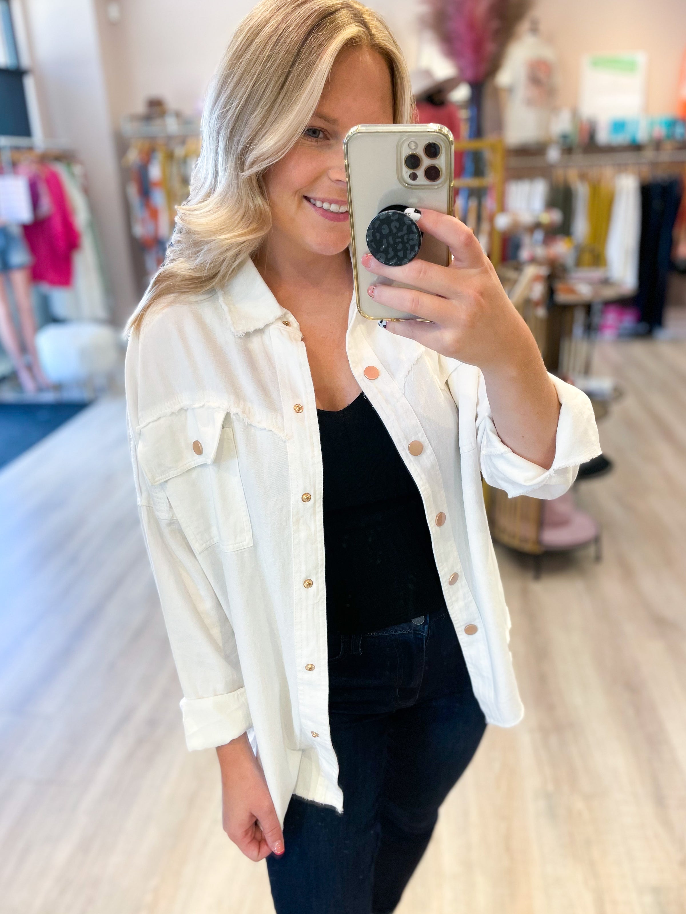 white denim jacket with black peace and peace sign on the back